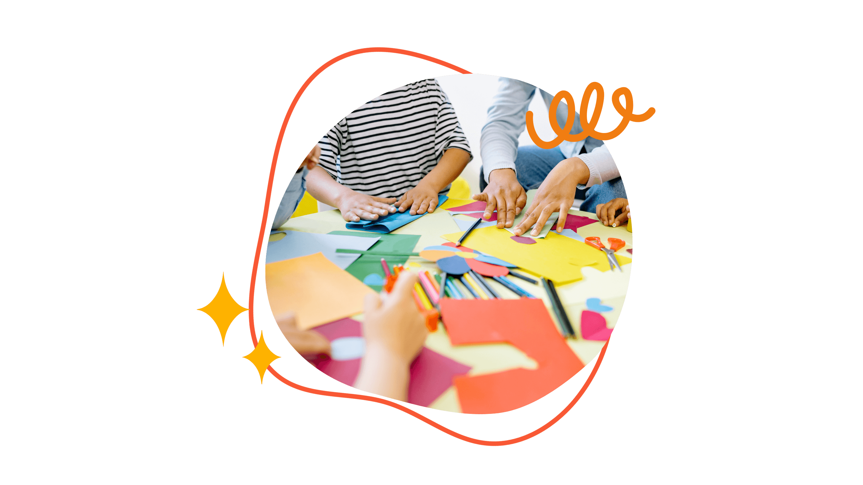 Kinderhände basteln und malen mit farbigem Papier und Scheren auf einem Tisch.